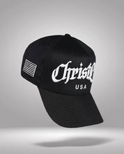 Black cap with 'Christlike USA' logo on a gray background